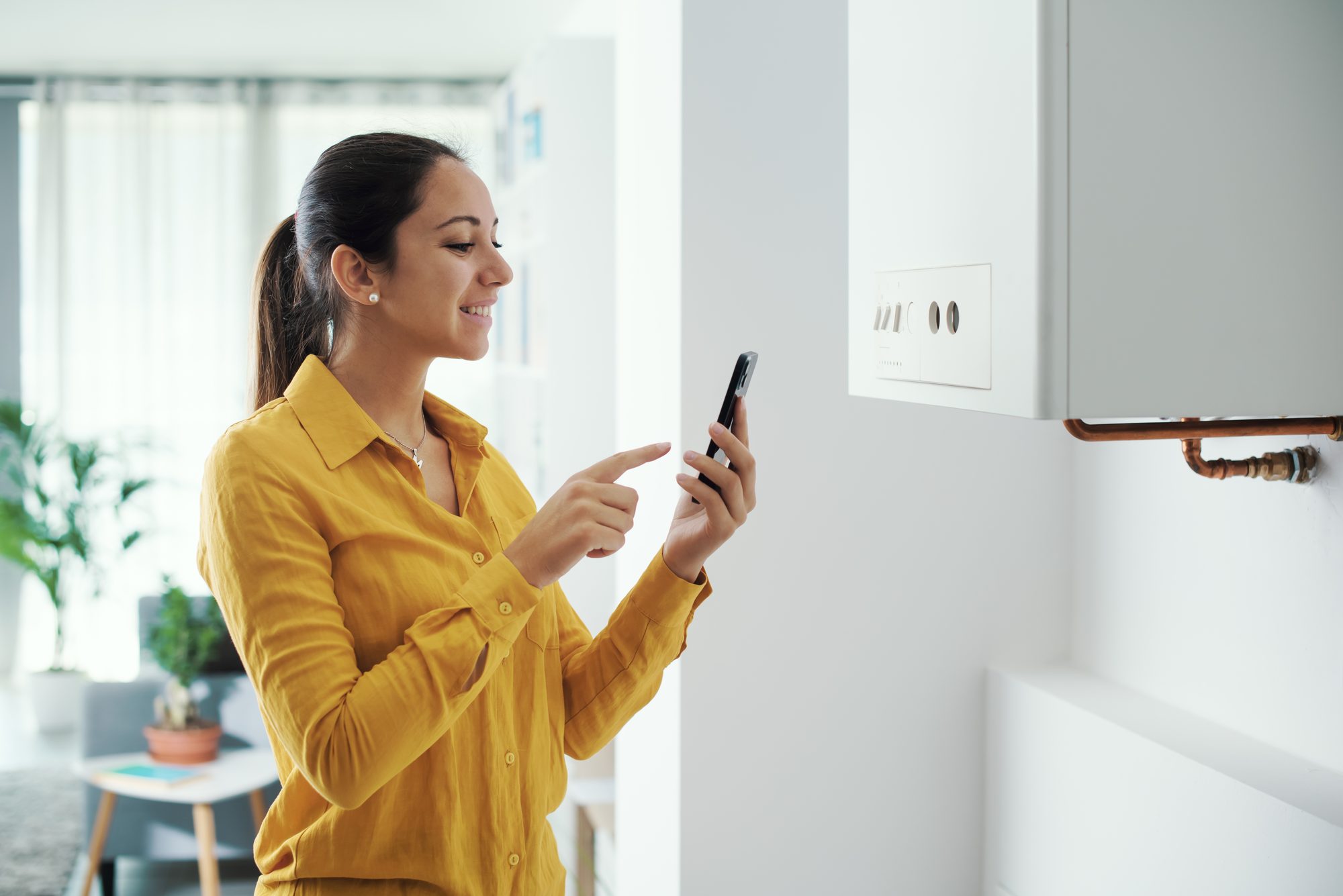 Customer in Wigan using a smartphone app to control her serviced natural gas boiler
